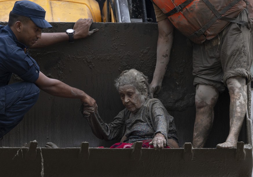KEYPIX - epa13193004 Rescuers transport an elderly woman rescued from a Devighat old age home following a flash flood in Trishuli Bazar, Nuwakot district, Nepal, 26 August 2026. Several people were ki ...