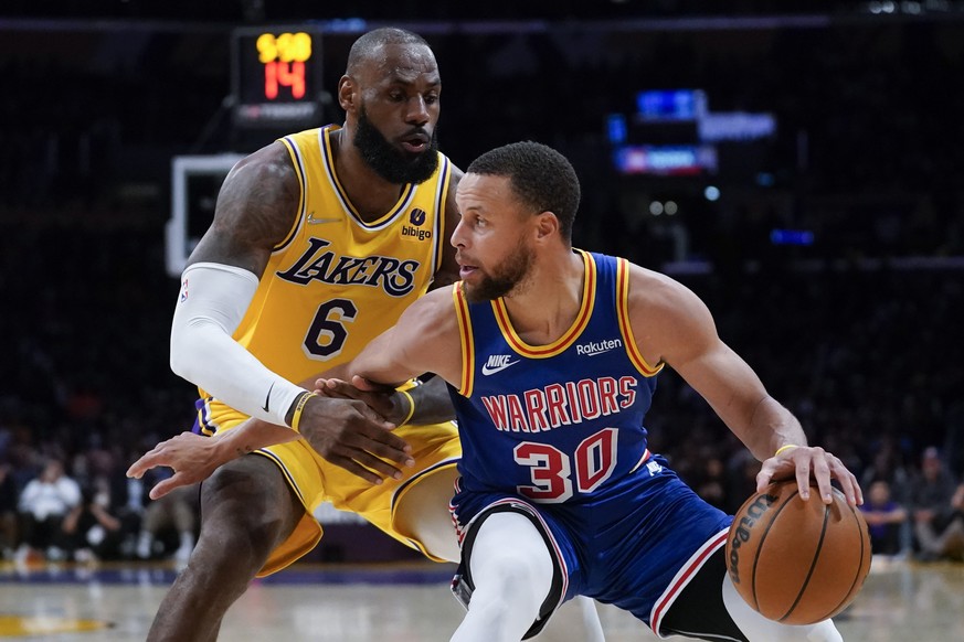 Los Angeles Lakers forward LeBron James (6) defends against Golden State Warriors guard Stephen Curry (30) during the second half of an NBA basketball game in Los Angeles, Saturday, March 5, 2022. (AP ...