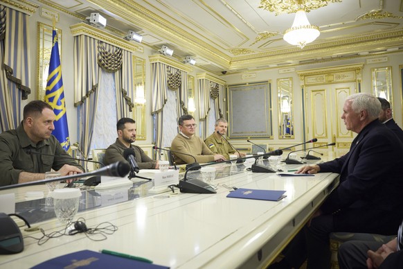 In this photo provided by the Ukrainian Presidential Press Office, Ukrainian President Volodymyr Zelenskyy, second left, listens to former US Vice President Mike Pence, right, during their meeting in  ...