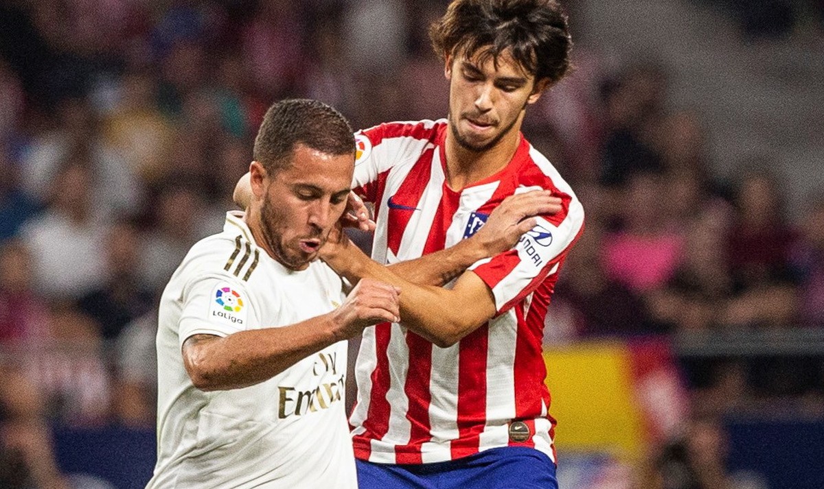 epa07877959 Real Madrid's Eden Hazard (L) in action against Atletico Madrid's Joao Felix during the LaLiga match between Atletico Madrid and Real Madrid at the Wanda Metropolitano stadium, i ...