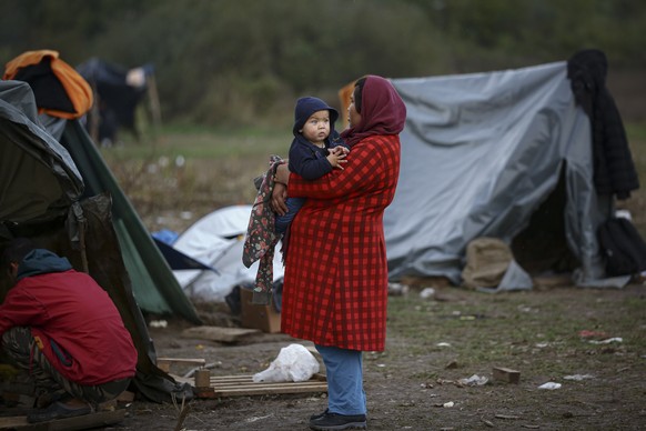 FILE – A migrant woman holds a baby at a makeshift camp housing migrants mainly from Afghanistan, in Velika Kladusa, Bosnia, on October 1.  June 12, 2021. German Chancellor Olaf Scholz on Thursday, June 22, 2023 d...