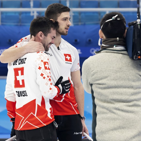 Switzerland skip Peter De Cruz, left reacts past his teammate Pablo Lachat, 2dn left, after the men&#039;s Round Robin #12 game between Sweden and Switzerland at the National Aquatics Centre at the 20 ...