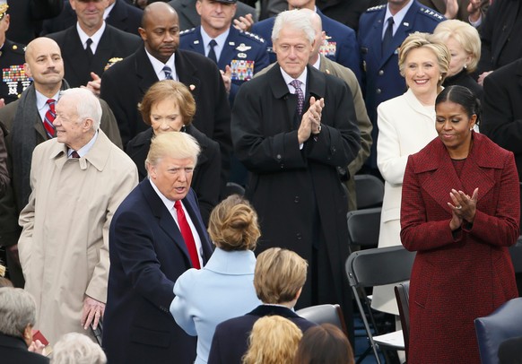 President-Elect Donald Trump greets his wife Melania in front of former presidents Jimmy Carter, Bill Clinton and George W Bush at the inauguration ceremonies swearing in Donald Trump as the 45th pres ...