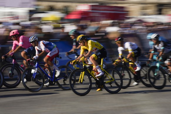 Tour de France winner Slovenia's Tadej Pogacar, wearing the overall leader's yellow jersey, rides in the pack during the twenty-first and last stage of the Tour de France cycling race over 108.4 kilometers (67.4 miles) with start in Chatou and finish on the Champs Elysees in Paris, France,Sunday, July 18, 2021. (AP Photo/Daniel Cole)