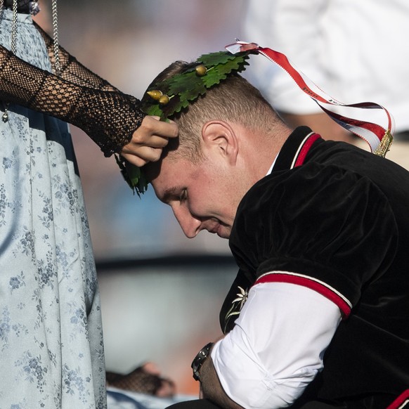 Joel Wicki wird von einer Ehrendame zum Koenig gekroent an der Schlussfeier des Eidgenoessischen Schwing- und Aelplerfests (ESAF) in Zug, am Sonntag, 25. August 2019. (KEYSTONE/Ennio Leanza)