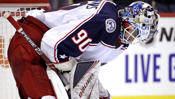 Columbus Blue Jackets goaltender Elvis Merzlikins collects himself after allowing the fifth goal of the second period during an NHL hockey game against the Pittsburgh Penguins in Pittsburgh, Saturday, ...