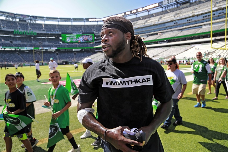 Miami Dolphins running back Jay Ajayi (23) and several other Dolphin players wear t-shirts in support of Colin Kaepernick before an NFL football game as the New York Jets host the Miami Dolphins at Me ...