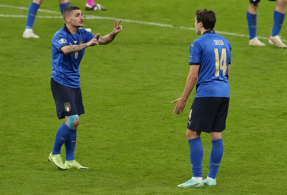 Italy's Federico Chiesa, right, gestures to teammate Marco Verratti during the Euro 2020 soccer championship semifinal between Italy and Spain at Wembley stadium in London, Tuesday, July 6, 2021. ...