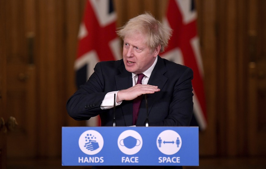 Britain&#039;s Prime Minister Boris Johnson speaks during a news conference in response to the ongoing situation with the coronavirus (COVID-19) pandemic, inside 10 Downing Street, London, Saturday, D ...