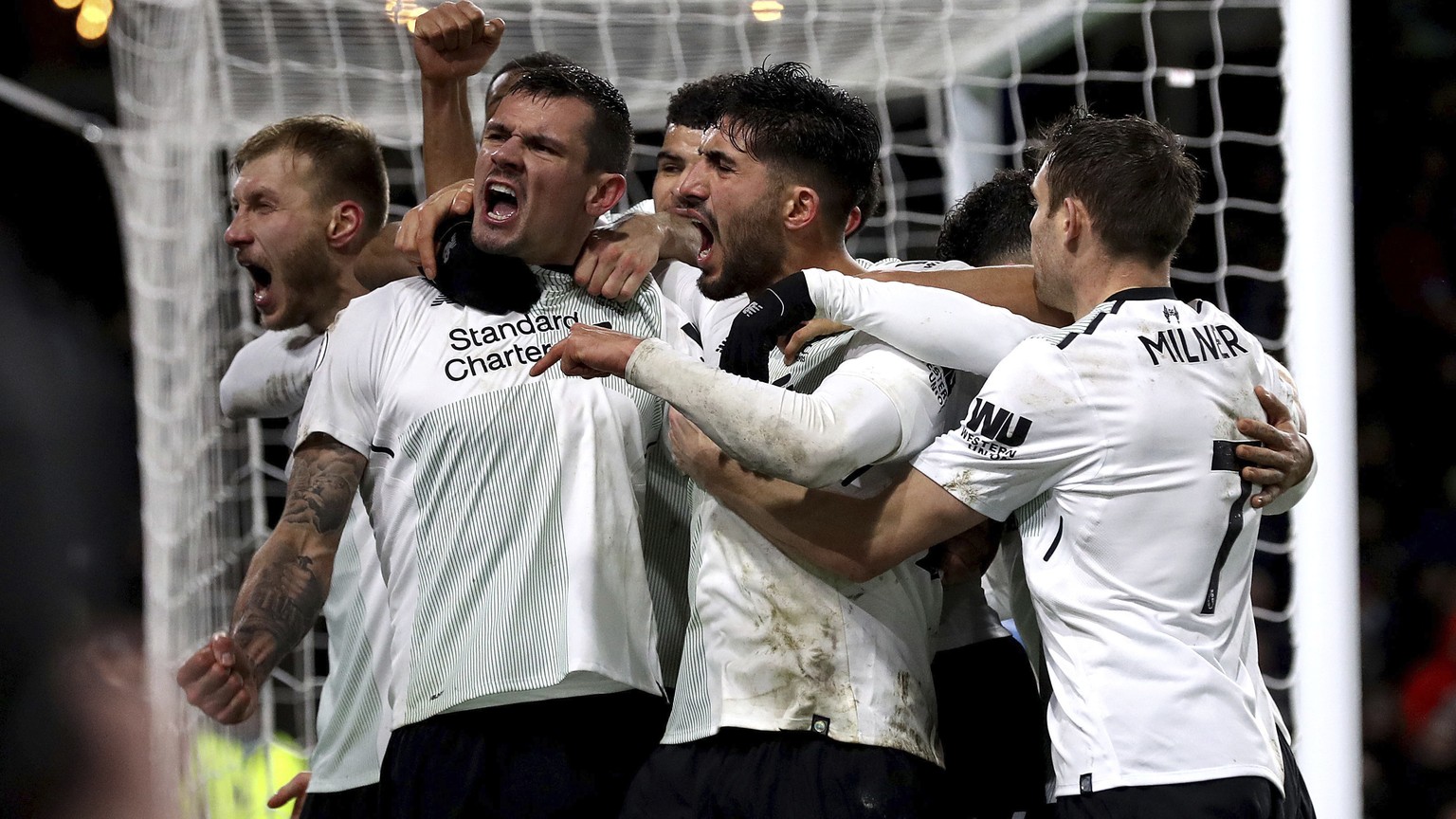 Liverpool&#039;s Ragnar Klavan, left, celebrates scoring his side&#039;s first goal of the game against Burnley with team-mates including Liverpool&#039;s Dejan Lovren, second left, during the English ...