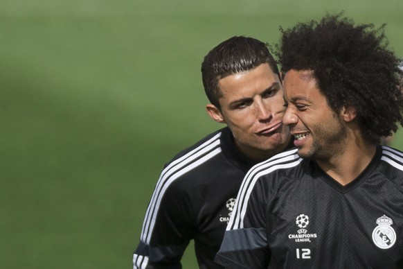 Real Madrid&#039;s Cristiano Ronaldo, jokes with teammate Marcelo, right, from Brazil during a training session at the Valdebebas sport complex, in Madrid, Spain, Monday, April 13, 2015. Real Madrid w ...