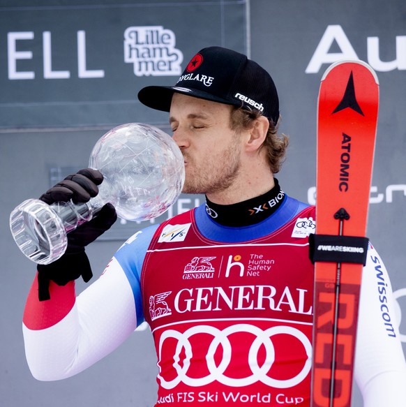 epa08277911 Mauro Caviezel from Switzerland, the winner of the Super-G Overall World Cup, kisses his Crystal Ball at an award ceremony after the World Cup in Super-G was canceled in Kvitfjell, Norway, ...