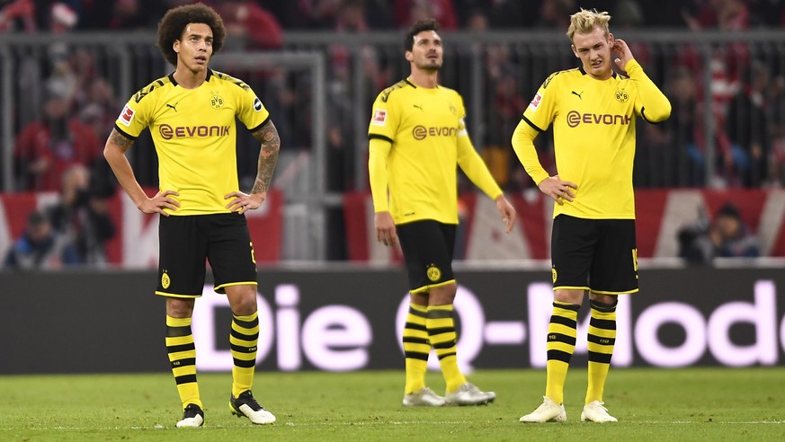 epa07984335 Dortmund&#039;s Axel Witsel (L-R), Dortmund&#039;s Mats Hummels and Dortmund&#039;s Julian Brandt react during the German Bundesliga soccer match between FC Bayern Munich and Borussia Dort ...