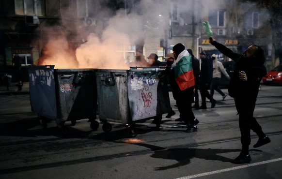 epa12563312 Protesters set a dumpster on fire during a rally against the 2026 national budget in Sofia, Bulgaria, 01 December 2025. The demonstration was organized by opposition parties to challenge t ...