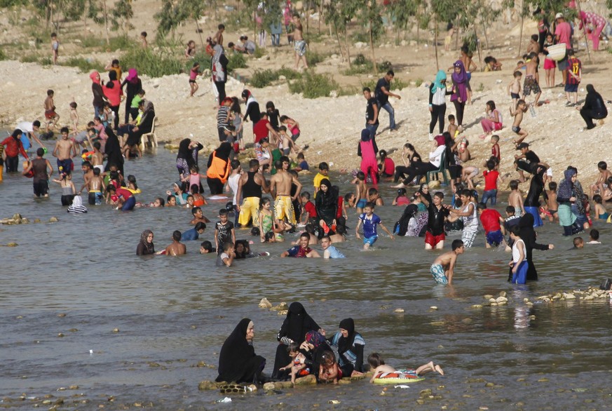 People enjoy the warm weather on a beach ahead of the holy fasting month of Ramadan at the port city of Sidon, southern Lebanon June 27, 2014. REUTERS/Ali Hashisho (LEBANON - Tags: SOCIETY ENVIRONMENT ...