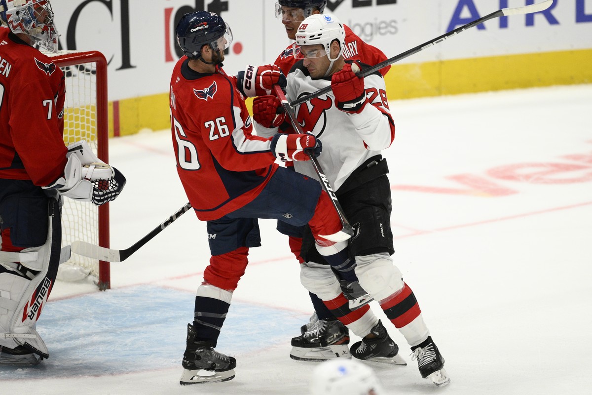 Washington Capitals center Nic Dowd (26) and New Jersey Devils right wing Timo Meier (28) scuffle during the third period of an NHL hockey game, Saturday, Oct. 12, 2024, in Washington. The Devils won  ...