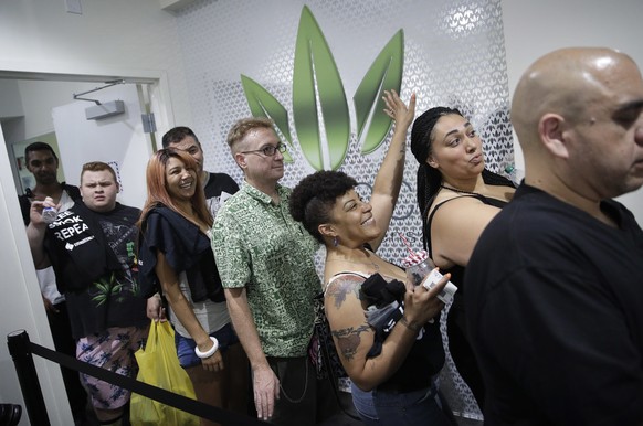 FILE- In this July 1, 2017 file photo, people wait in line at the Essence cannabis dispensary in Las Vegas. A judge cleared the way Thursday, July 17, for Nevada to allow more businesses to move marij ...