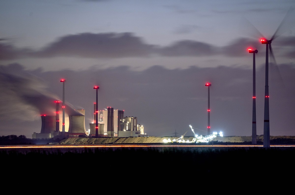 Steam rises from the coal-fired power plant near wind turbines Neurath near Grevenbroich, Germany, Wednesday, Nov. 2, 2022. (AP Photo/Michael Probst)