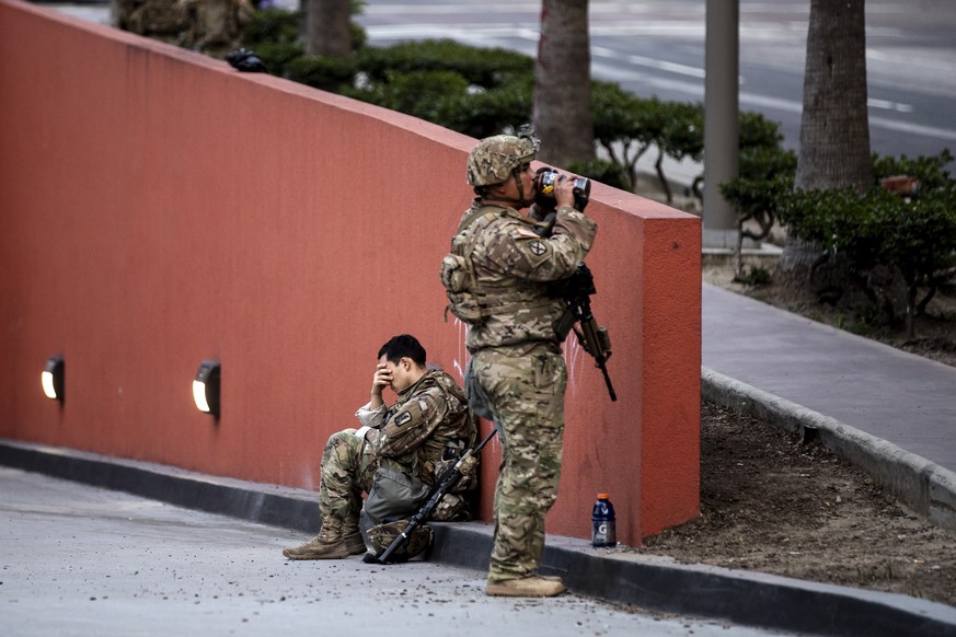 epa08457177 National guard members stand guard in Pershing Square after violent protests over the death of George Floyd, who died in police custody, at Pershing Square in Los Angeles, California, USA, ...
