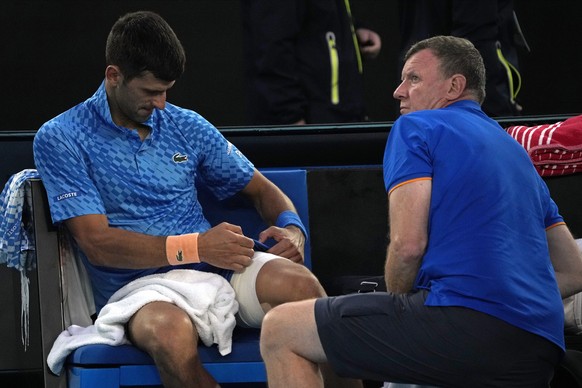 Serbian Novak Djokovic receives treatment for a leg injury during his third round match against Grigor Dimitrov of Bulgaria at the Australian Open tennis tournament in Melbourne, Australia, Saturday...