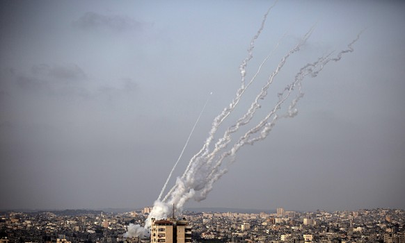 FILE - In this May 10, 2021 file photo, rockets are launched from the Gaza Strip towards Israel. A number of Palestinian journalists in the Gaza Strip say they are being blocked from accessing WhatsAp ...