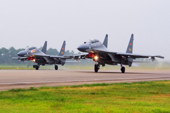 FILE - In this undated file photo released by China's Xinhua News Agency, two Chinese SU-30 fighter jets take off from an unspecified location to fly a patrol over the South China Sea. China flew more ...