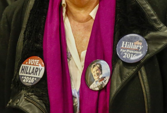 epa05205524 A supporter wears campaign buttons as she waits for US Democratic presidential candidate Hillary Clinton to arrive at a campaign event at the Sullivan Community Center and Family Aquatic C ...