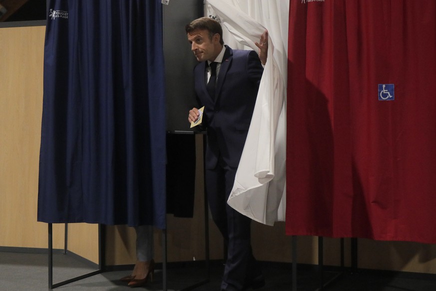 French President Emmanuel Macron leaves the voting booth Sunday, June 19, 2022 in Le Touquet, northern France. French voters are going to the polls in the final round of key parliamentary elections th ...