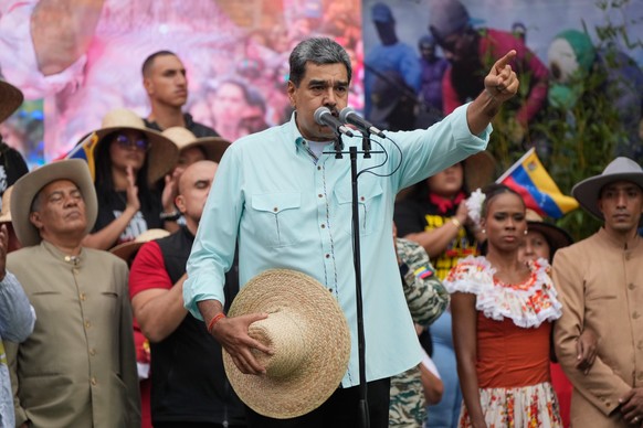 Nicolas Maduro speaks at a rally marking the anniversary of the Battle of Santa Isabel, which took place during Venezuela's 19th-century Federal War, in Caracas, Venezuela, Wednesday, Dec. 10, 20 ...