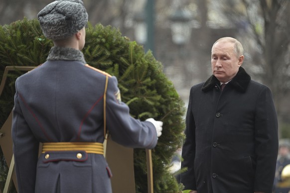 Russian President Vladimir Putin attends a wreath-laying ceremony at the Tomb of the Unknown Soldier, near the Kremlin Wall during the national celebrations of the &#039;Defender of the Fatherland Day ...