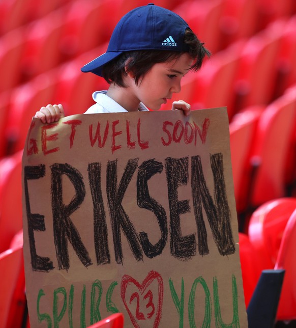 epa09267625 A young fan holds a sign dedicated to Danish soccer player Christian Eriksen during the UEFA EURO 2020 group D preliminary round soccer match between England and Croatia in London, Britain ...