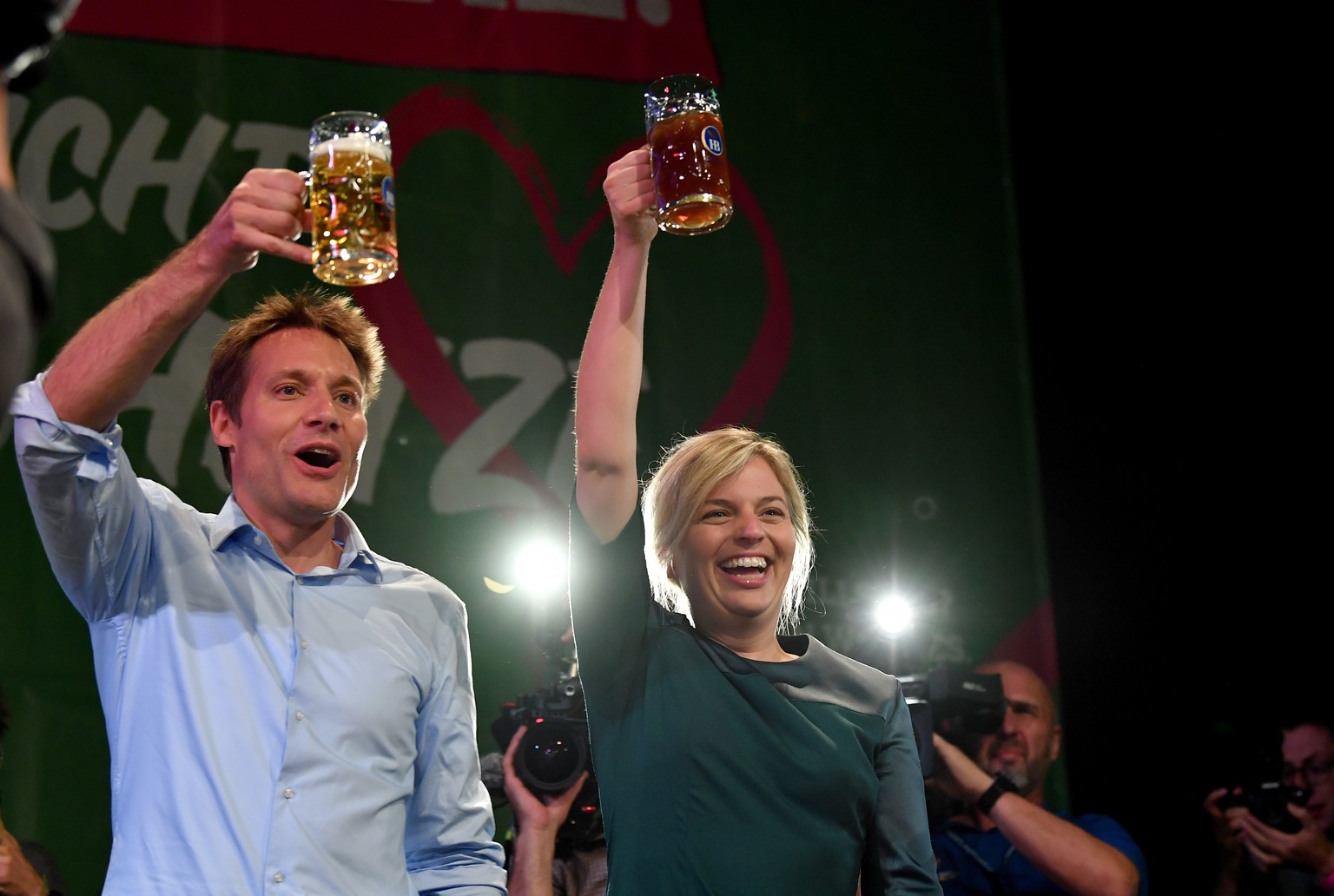 epa07093460 Alliance 90/The Greens party leading candidates Ludwig Hartmann (L) and Katharina Schulze (R) celebrate on an election event during the Bavaria state elections in Munich, Germany, 14 Octob ...