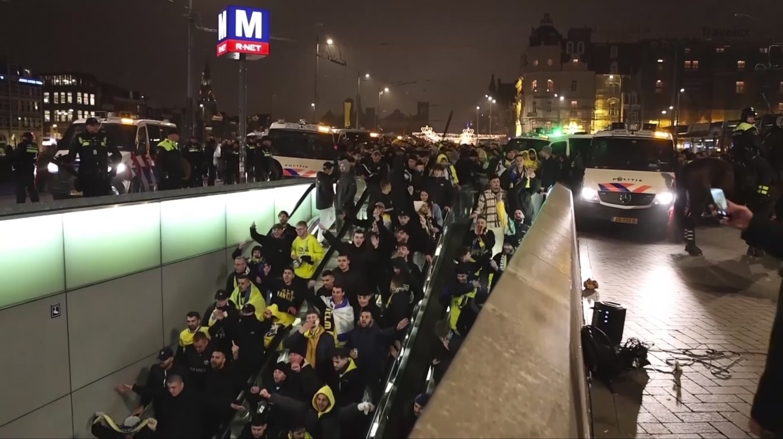 In this image taken from video, police escort Maccabi Tel Aviv supporters to the metro, after pro-Palestinian supporters marched near the soccer stadium, in Amsterdam, the Netherlands, Thursday, Nov.  ...