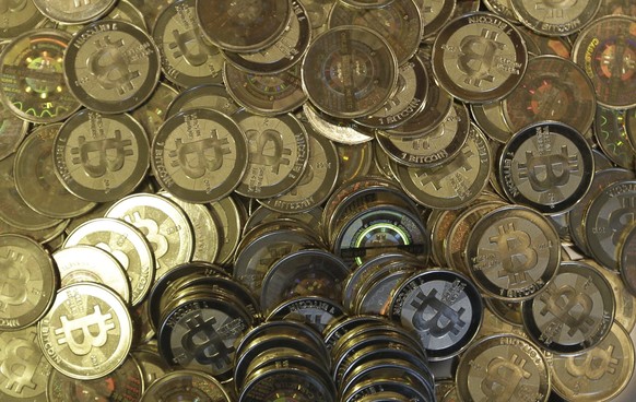 FILE - This April 3, 2013 photo shows bitcoin tokens at software engineer Mike Caldwell's shop in Sandy, Utah.  The Federal Reserve Board has rejected a Wyoming cryptocurrency bank's application for Fede.