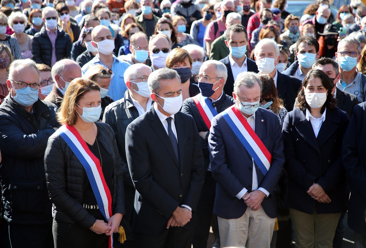 The sub prefect Herve Jonathan, second left, surrounded by local elected officials, observe a minute of silence in Bayonne, southwestern France, Sunday, Oct. 18, 2020, in memory of the teacher Samuel  ...