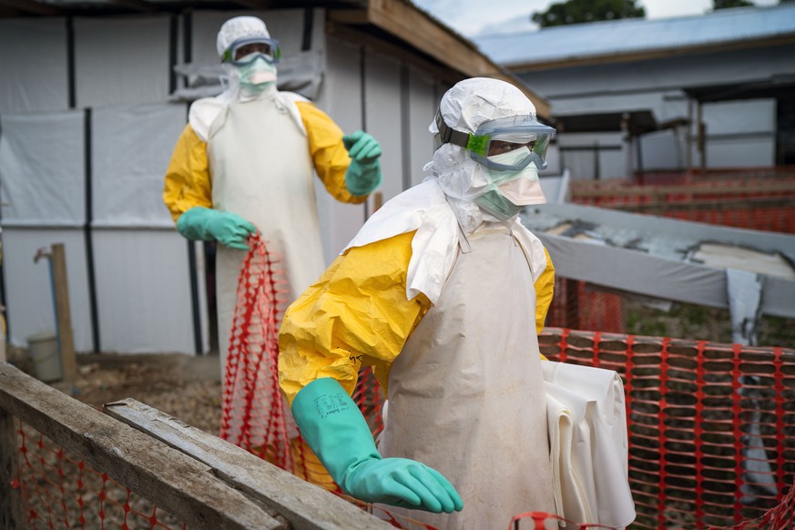 In this photograph taken Saturday July 13, 2019, health workers wearing protective suits take their shift at a treatment center in Beni, Congo DRC. The head of the World Health Organization is conveni ...