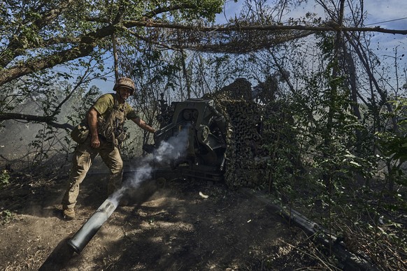 A Ukrainian serviceman of the 31 Brigade fires a D-30 cannon towards Russian positions at the front line in Donetsk region, Ukraine, Wednesday, Aug. 9, 2023. (AP Photo/Libkos)