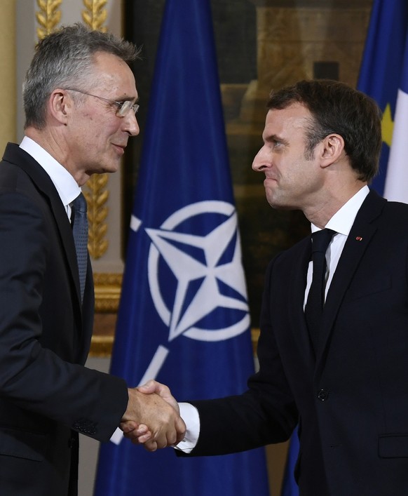 French President Emmanuel Macron, right, shakes hands with NATO Secretary General Jens Stoltenberg, during a joint press conference at the Elysee palace, Thursday, Nov.28, 2019 in Paris. French Presid ...