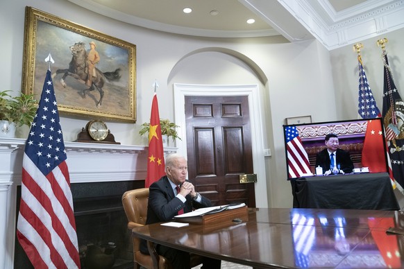 epa09584543 US President Joe Biden listens during a virtual summit with Chinese President Xi Jinping in the Roosevelt Room of the White House in Washington DC, USA, 15 November 2021. EPA/SARAH SILBIGE ...