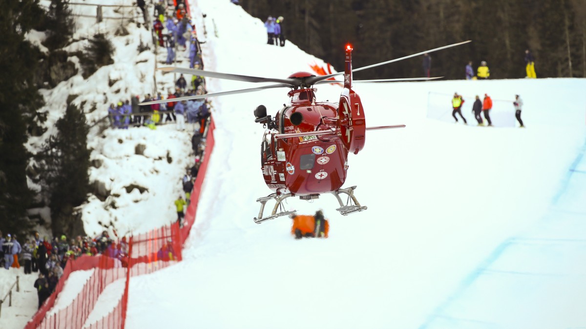 A rescue helicopter leaves with on board Switzerland's Marc Gisin after he crashed on the course during a men's World Cup downhill, in Val Gardena, Italy, Saturday, Dec. 15, 2018. (AP Photo/ ...