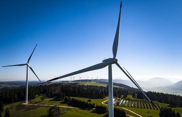 Wind turbines from the JUVENT power plant and solar panels from the solar station of the Mont-Soleil are pictured on the Mont-Soleil in Saint-Imier, Switzerland on Wednesday May 10, 2017. The Swiss pe ...