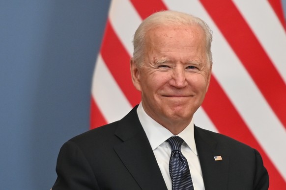 epa09273630 US President Joe Biden smiles during a bilateral meeting with Swiss president of the Swiss confederation Guy Parmelin (not pictured) ahead of a meeting with Russian counterpart Vladimir Pu ...