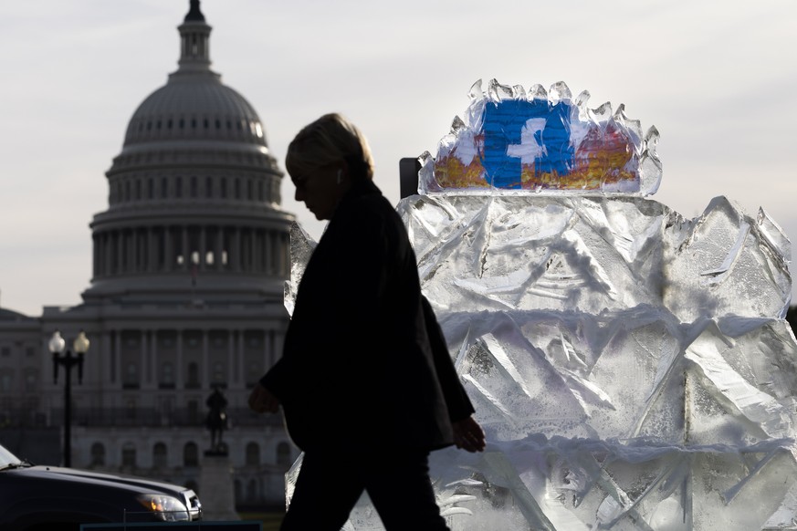 epa09563665 The activist group SUMOFUS.org displays a 5,000 pound piece of ice with the Facebook logo to protest what they called ���Facebook���s role in promoting climate misinformation��� on the Nat ...