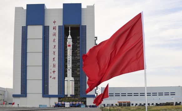 In this photo released by Xinhua News Agency, the Shenzhou-12 manned spaceship with its Long March-2F carrier rocket is being transferred to the launching area of Jiuquan Satellite Launch Center in no ...