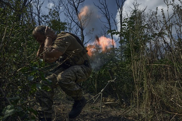 A Ukrainian soldier fires a mortar towards the Russian positions near Bakhmut, Donetsk region, Ukraine, Saturday, Sept. 2, 2023. (AP Photo/Libkos)
