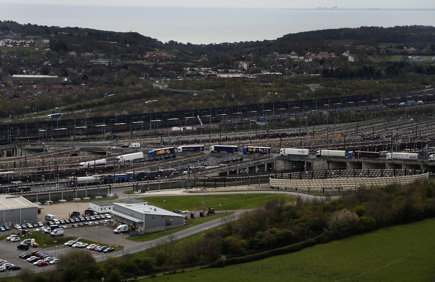 Trucks queue to board a train through Eurotunnel in Folkestone, England, Friday, April 5, 2019. (AP Photo/Frank Augstein)