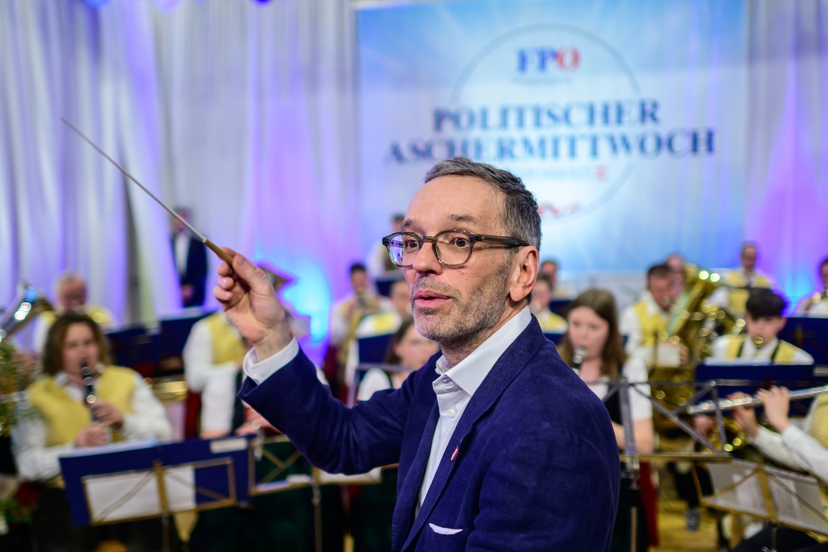 epa11153515 Herbert Kickl, leader of the right-wing Austrian Freedom Party (FPOe), conducts an orchestra during the party's traditional political Ash Wednesday meeting in Ried im Innkreis, Austri ...