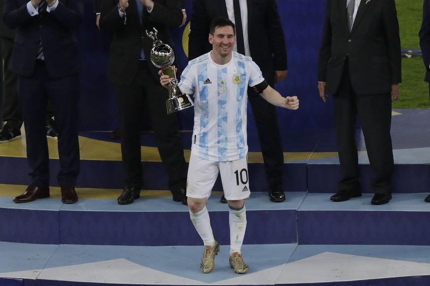 Argentina&#039;s Lionel Messi celebrates with the trophy for the top scorer of the Copa America after defeating Brazil 1-0 in the final match at Maracana stadium in Rio de Janeiro, Brazil, Saturday, J ...