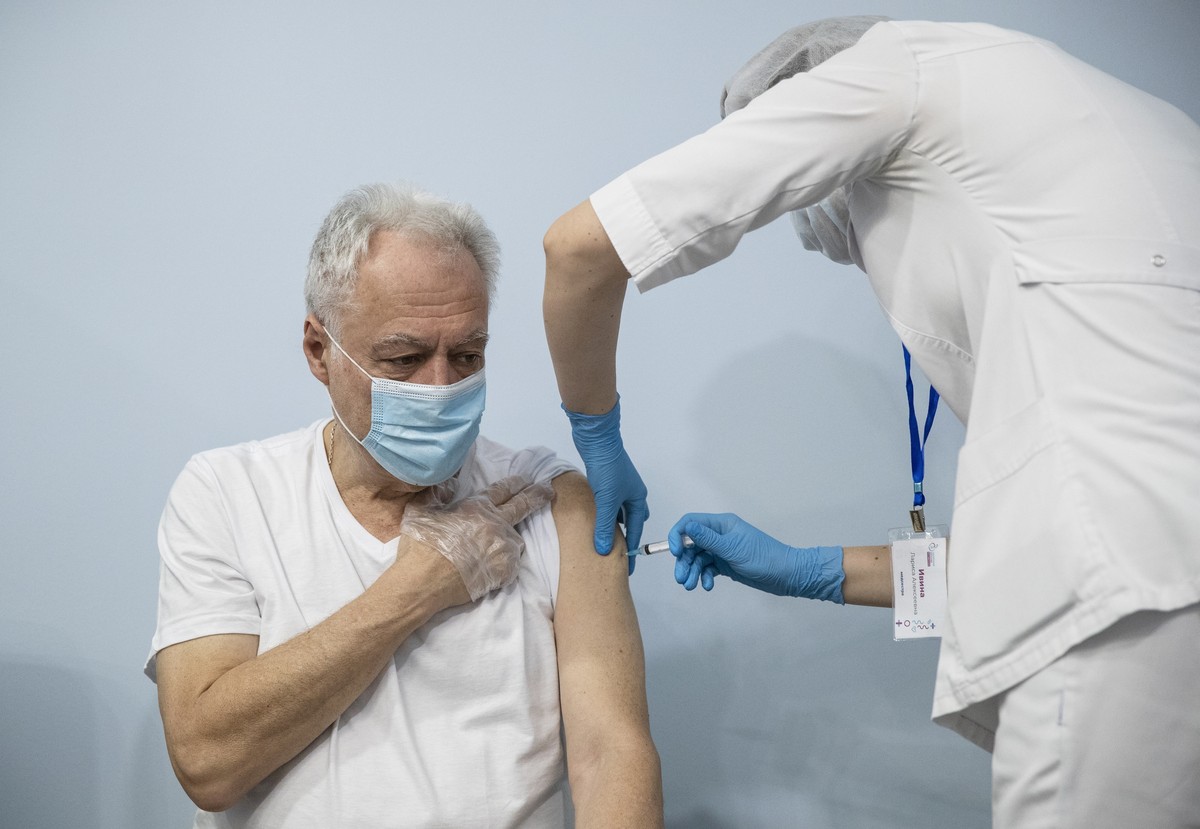 FILE - In this Jan. 20, 2021, file photo, a Russian medical worker, right, administers a shot of Russia's Sputnik V coronavirus vaccine to a patient in a vaccination center in Moscow, Russia. Rus ...