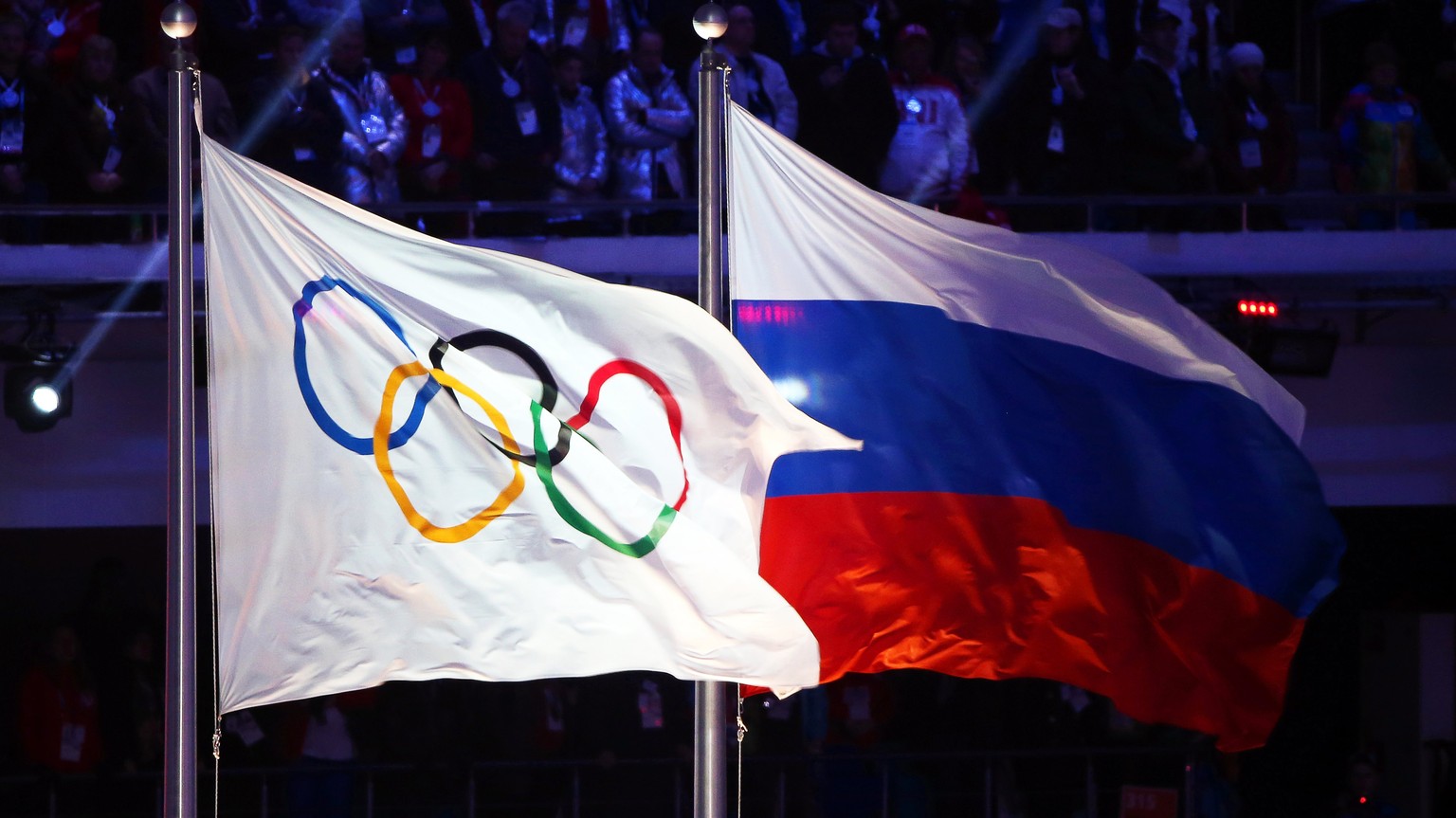 epa06369455 (FILE) - The Olympic flag (L) and the Russian flag (R) during the Closing Ceremony of the Sochi 2014 Olympic Games in the Fisht Olympic Stadium in Sochi, Russia, 23 February 2014 (reissued ...